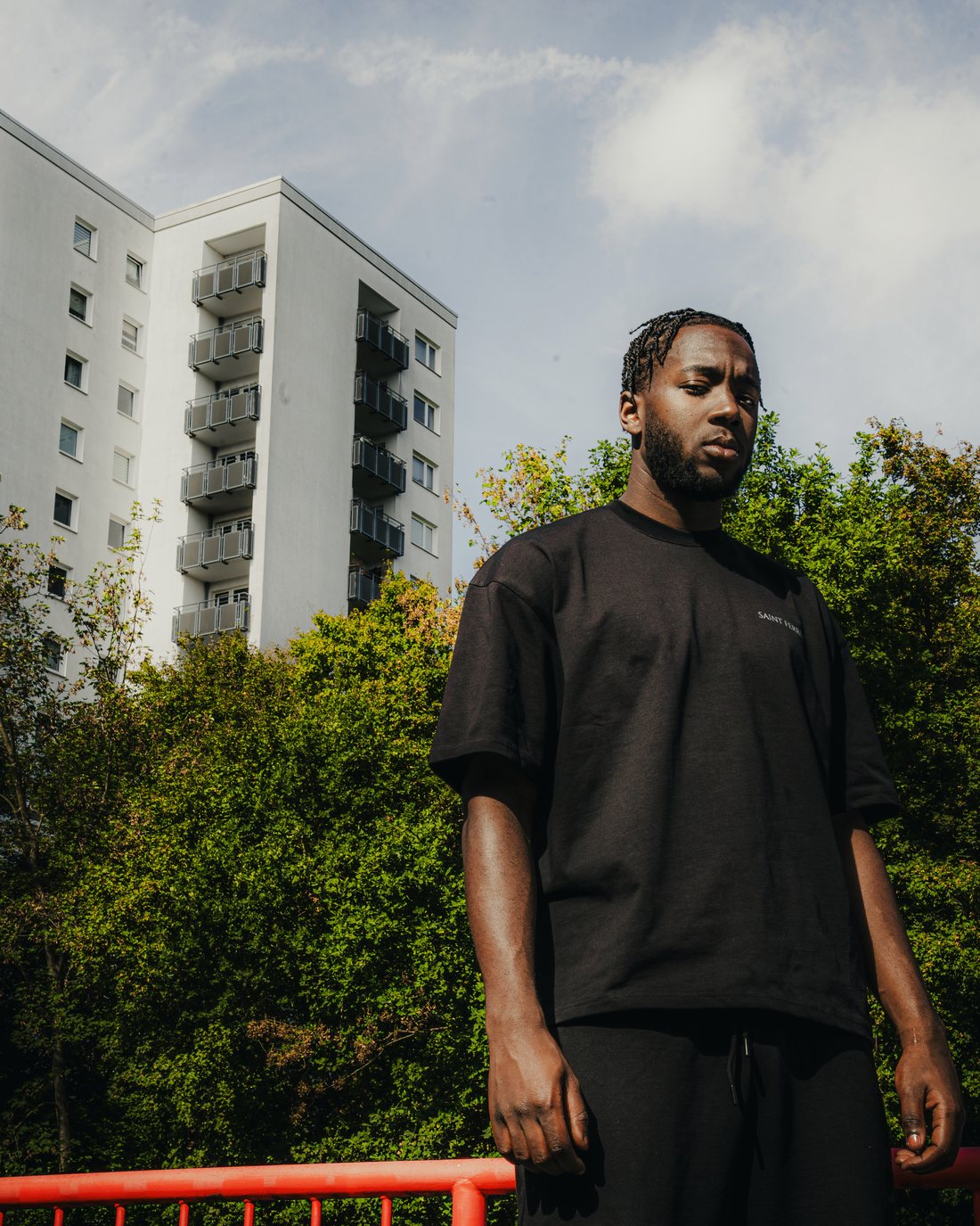 The Forge Tee in Ferro Black, Hamburg high-rise behind